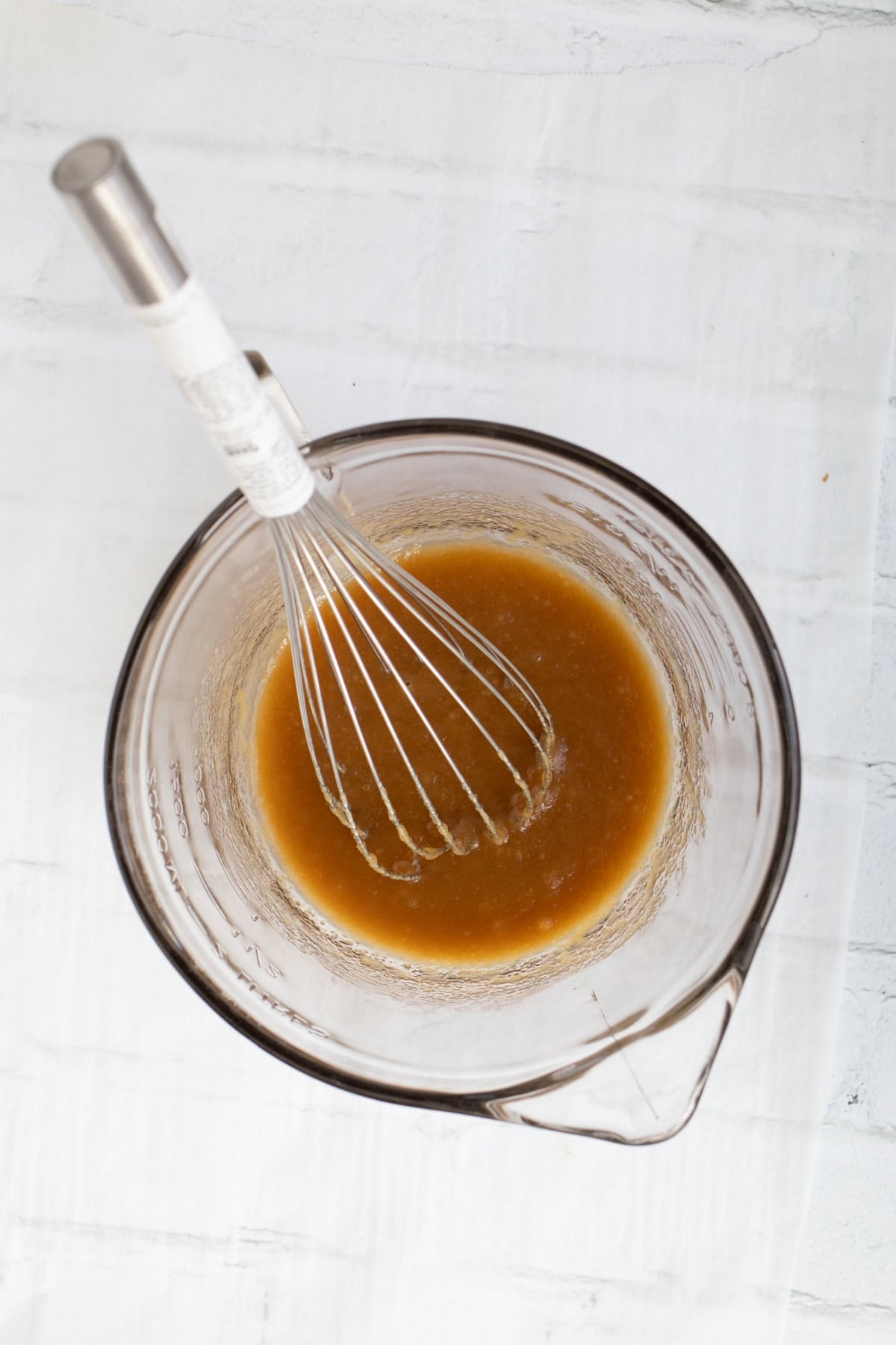 brown sugar and butter with a whisk in a mixing bowl.