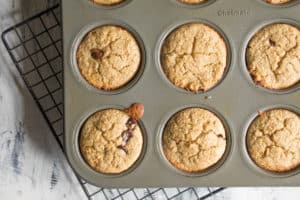 blender banana muffins in a muffin tin on a cooling rack
