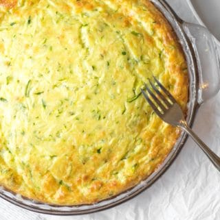 zucchini quiche in glass bowl with fork on the side