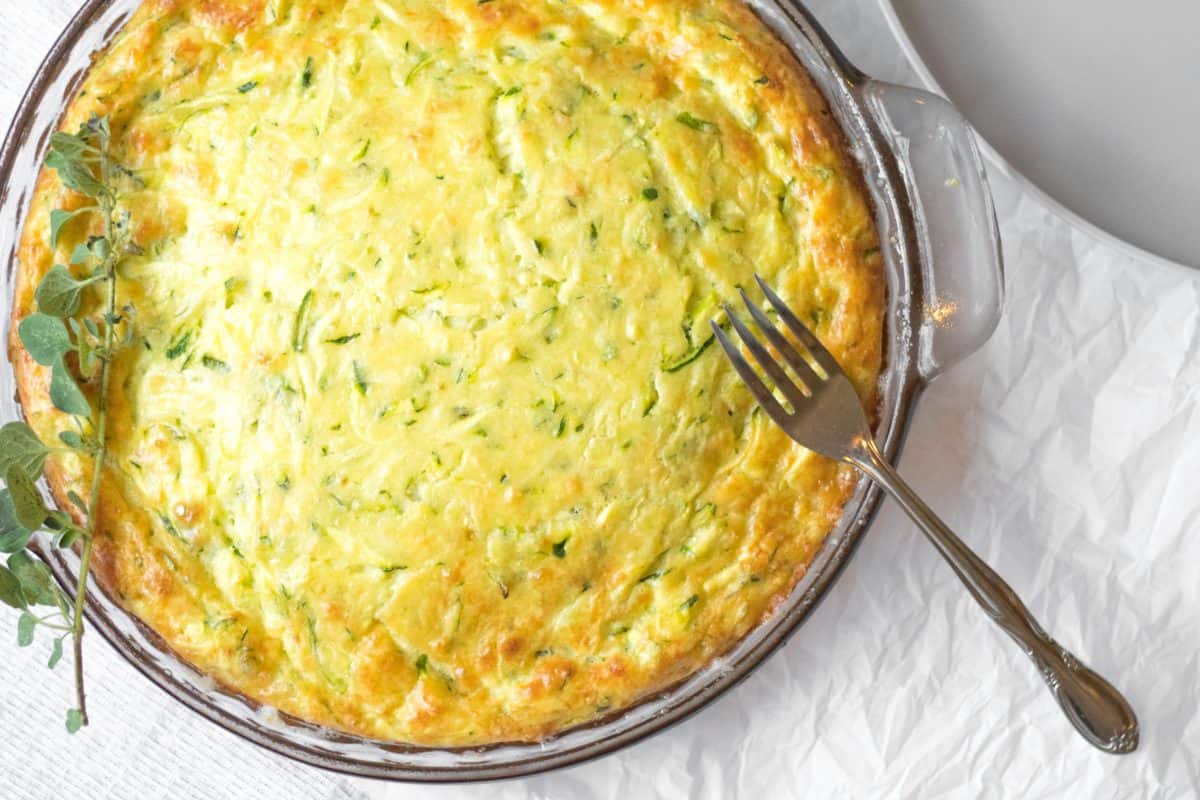 zucchini quiche in glass bowl with fork on the side