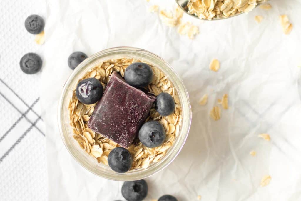 overnight oats with blueberry puree and whole blueberries on top