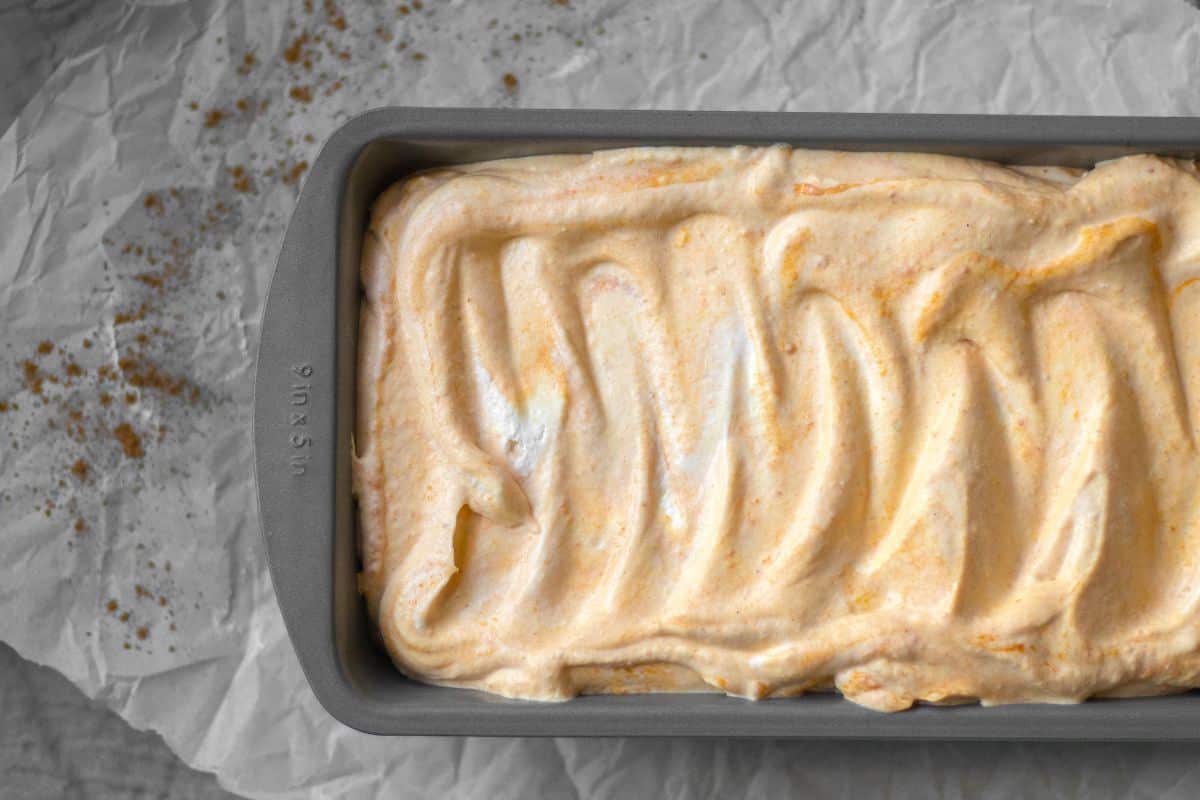 unfrozen pumpkin ice cream in a loaf pan.