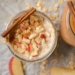 apple pie overnight oats in a mason jar with a cinnamon stick on top