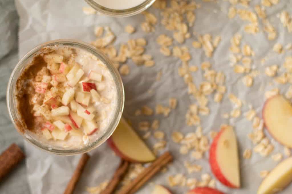 apple pie overnight oats mixed up with diced apples on top