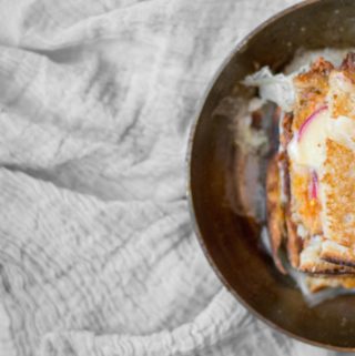 crispy fancy grilled cheese sandwich with apples and melty cheese in a small pan