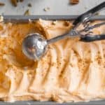 no churn pumpkin ice cream in a loaf pan with scoop