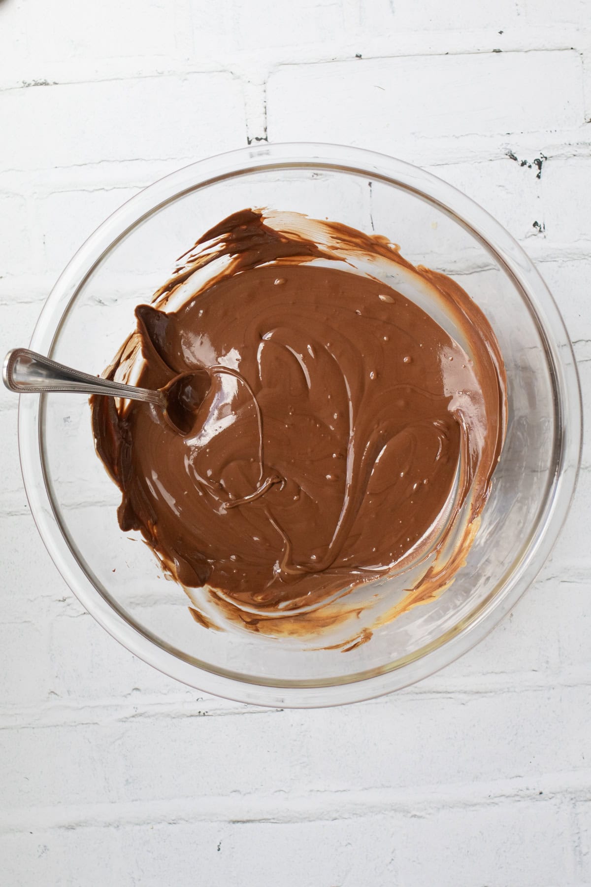 chocolate and peanut butter melted together in a glass bowl.