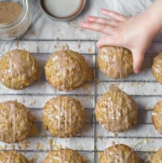 kids hand grabbing a chai spice muffin off a cooling rack