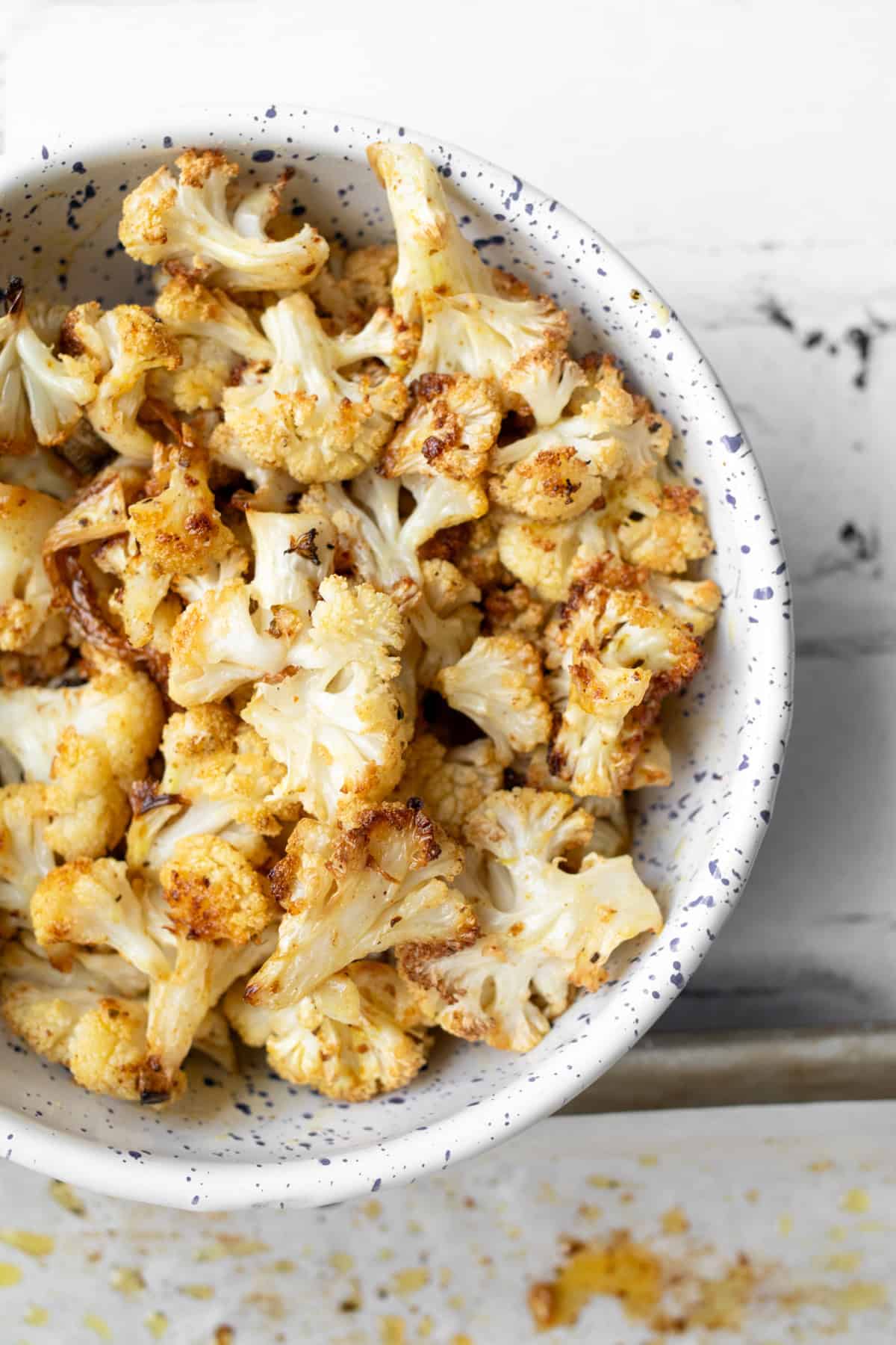 spice roasted cauliflower in a serving bowl.
