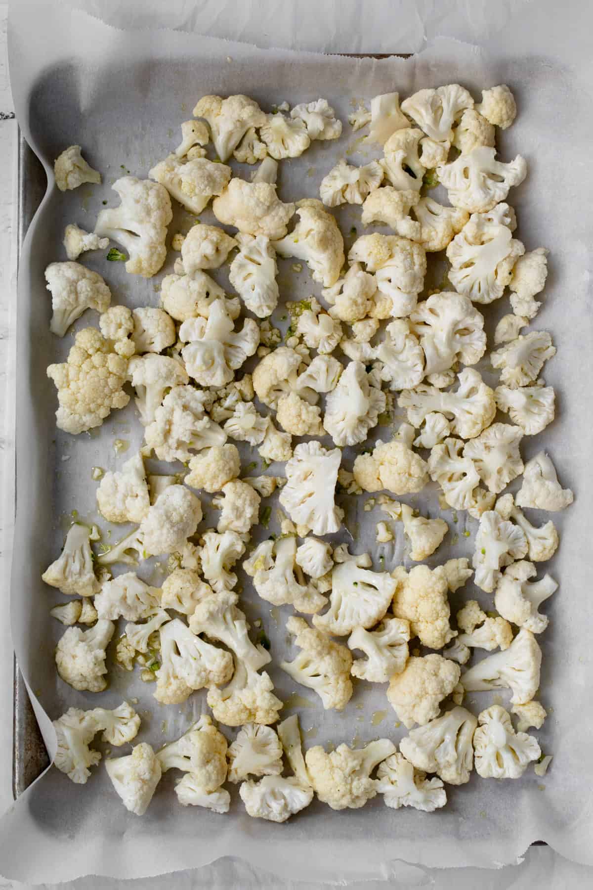 Roasted cauliflower florets on baking sheet.