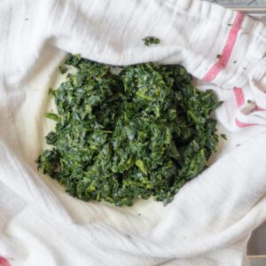 defrosted spinach on a dish towel