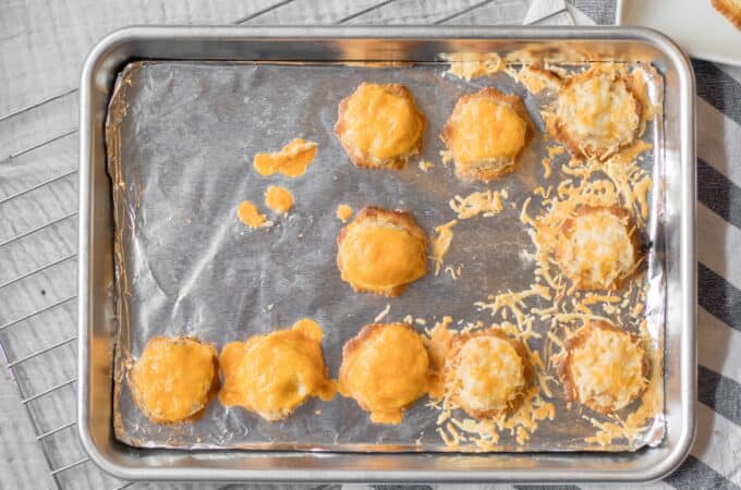 tiny tuna melts on a baking sheet with one missing from the pan