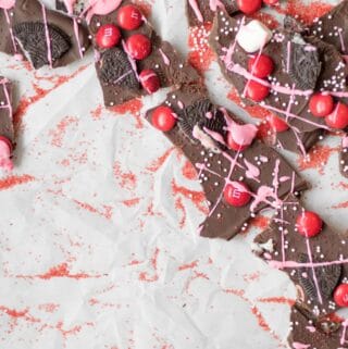 chocolate bark with red m&m's, pink drizzle, and crushed oreos
