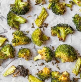 roasted broccoli on parchment paper lined sheet pan
