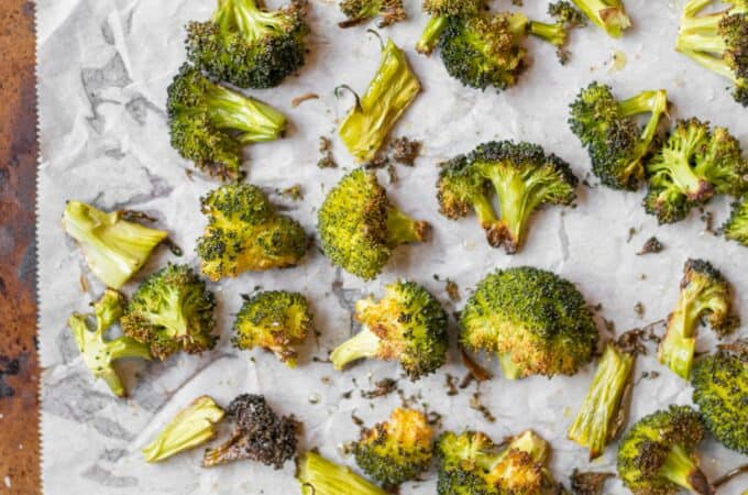 roasted broccoli on parchment paper lined sheet pan