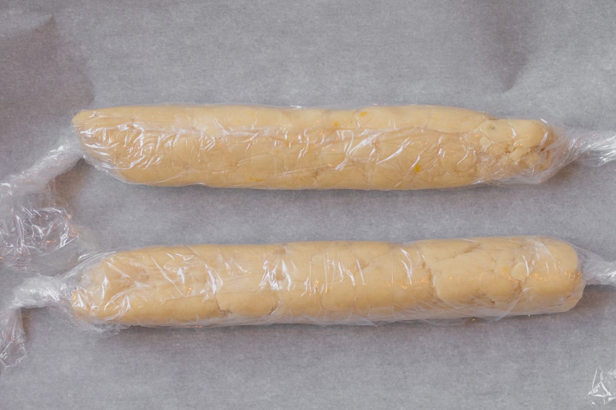 two logs of cookie dough wrapped in plastic wrap