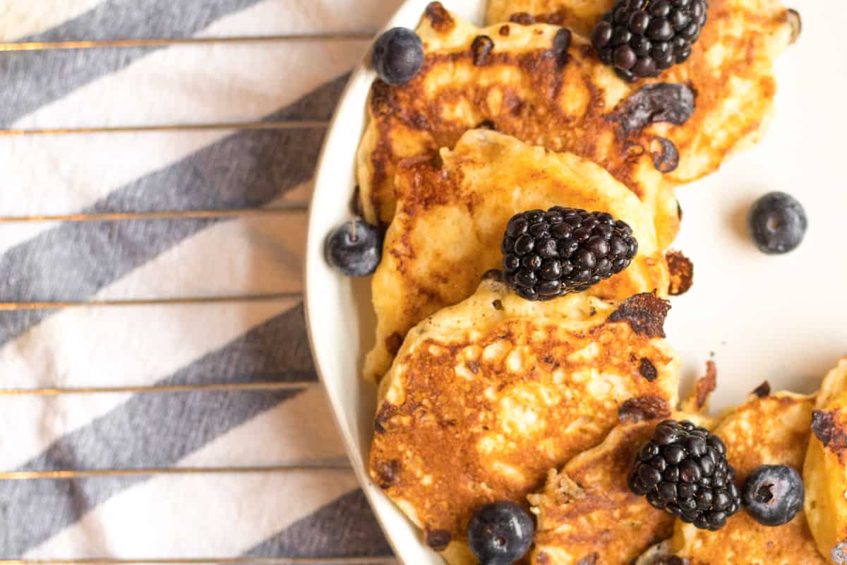 cottage cheese pancakes on a plate with blackberries