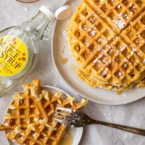 freezer waffles on a plate with an empty jar of maple syrup