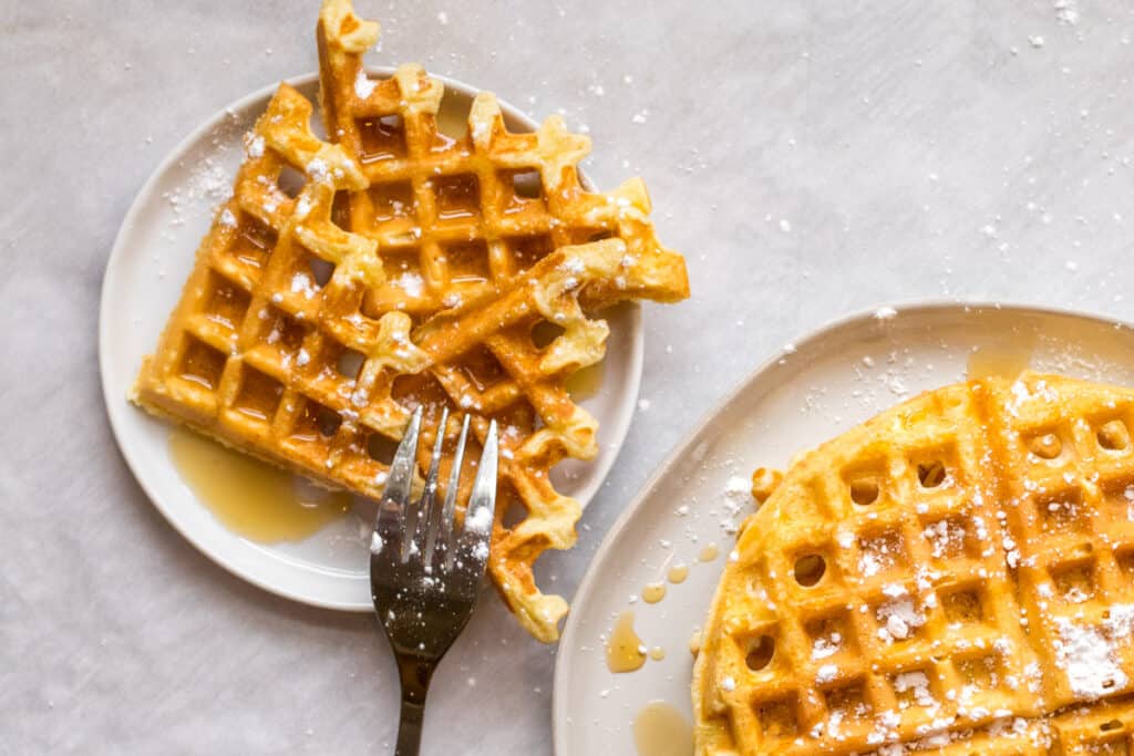 pieces of waffle on a plate with a fork