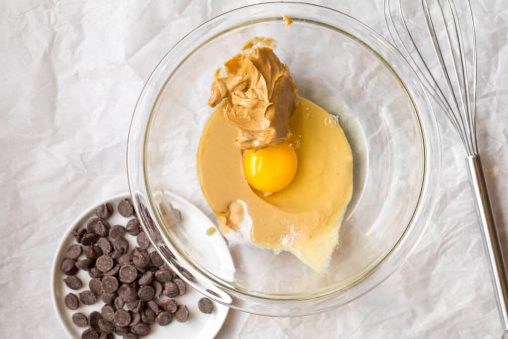 egg, peanut butter, tahini, maple syrup and baking soda in a glass bowl