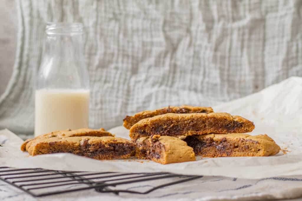 peanut butter chocolate chip tahini bars with a glass of milk