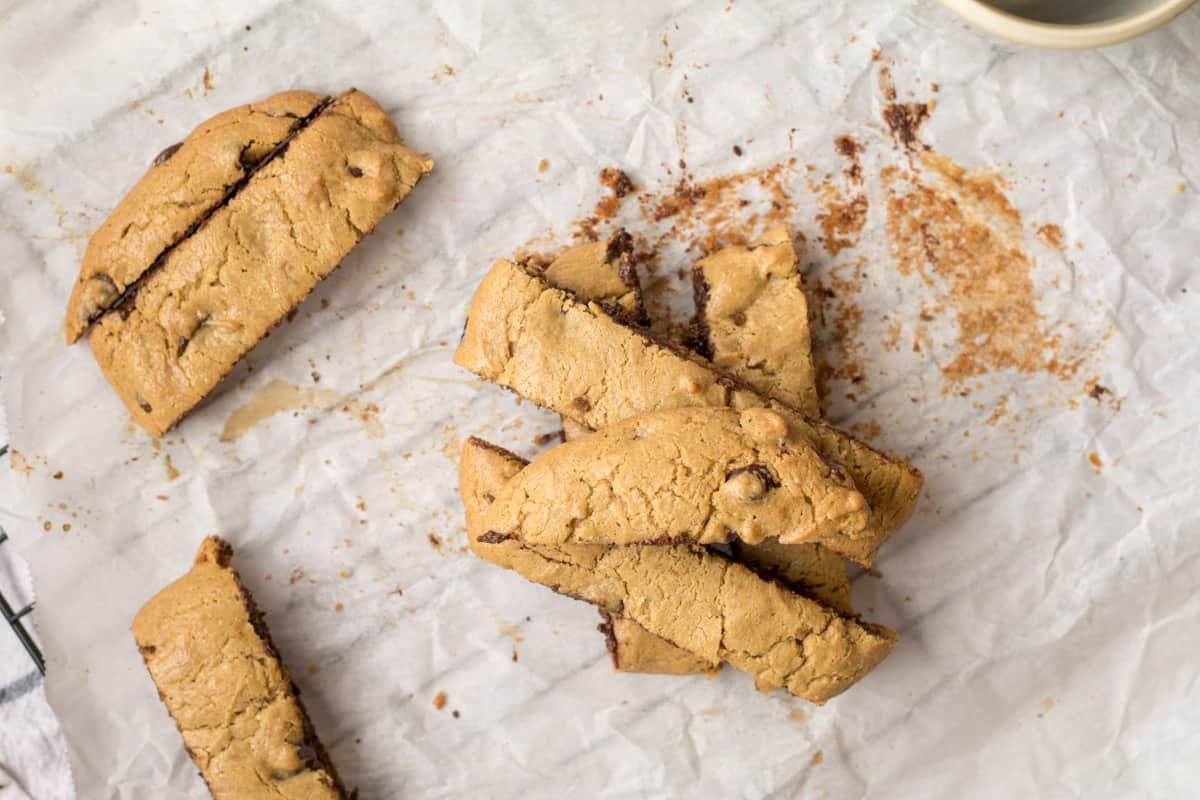 pile of peanut butter tahini chocolate chip cookie bars on parchment paper