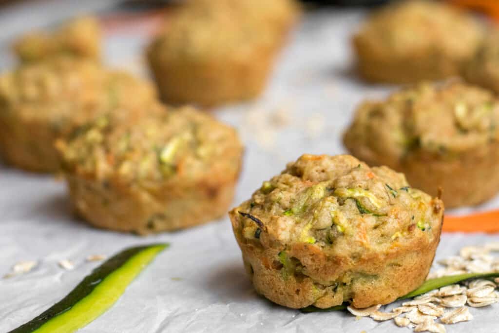 zucchini carrot muffins on parchment paper
