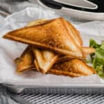 cooked grilled cheese toasties on a platter