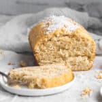 coconut bread with a slice on a plate
