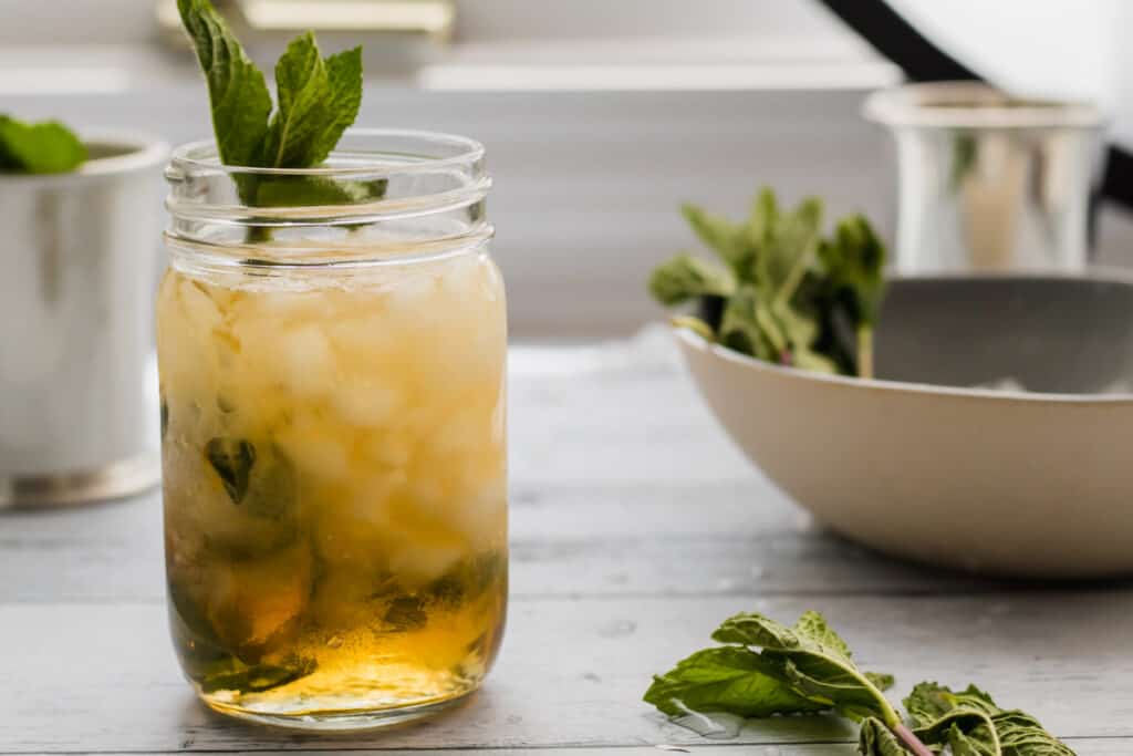 mason jar mint julep with mint garnish