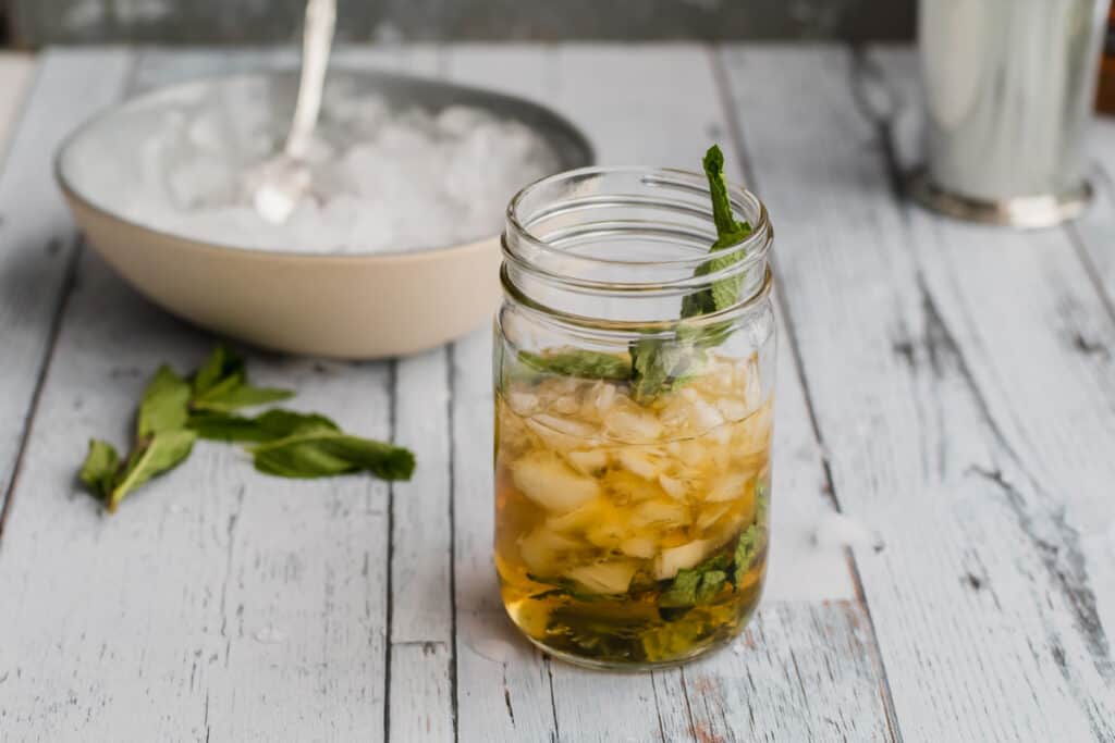 crushed ice being added to a mint julep