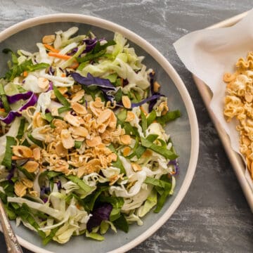 asian cabbage crunch salad with crunchy topping next to it