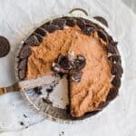 chocolate pudding pie with a slice removed, garnished with crushed oreos