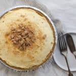 vanilla pudding pie with graham cracker crumbs on top, with a fork and serving utensil