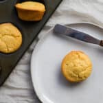 mochi muffin on a plate next to a muffin tin