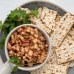 charoset in a bowl surrounded by pieces of matzo