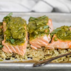 pesto salmon pieces on a bed of wild rice