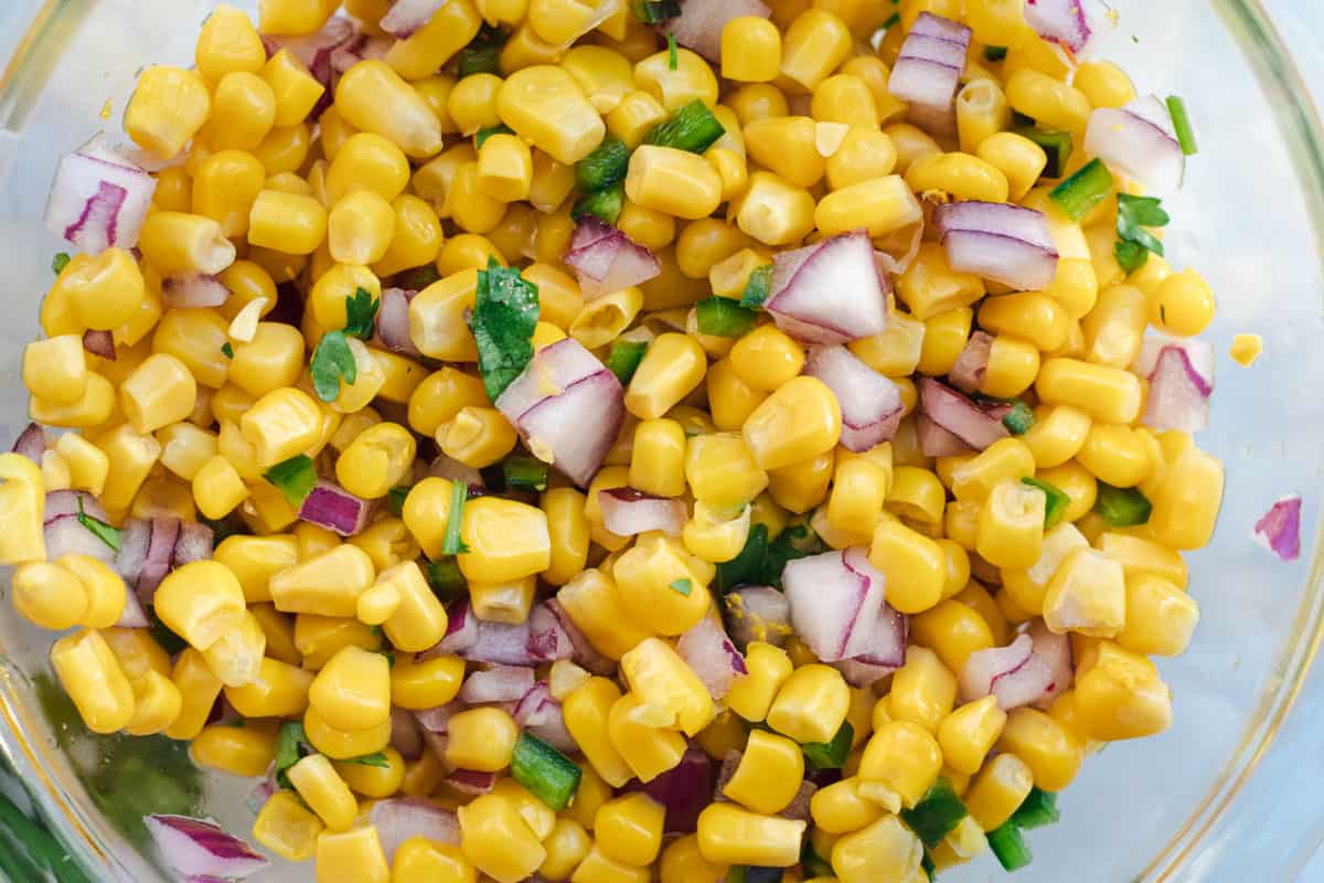 close up of corn salsa in a glass bowl