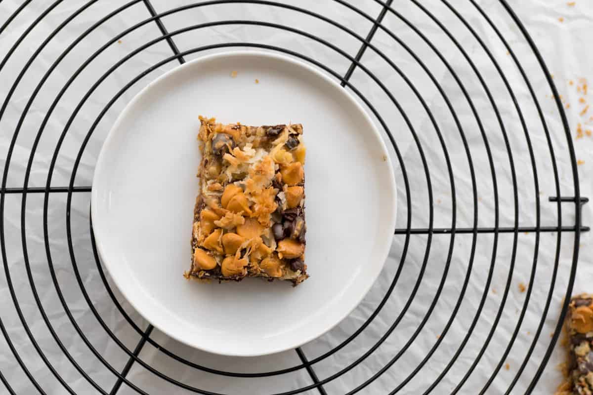 one cookie on a white plate on a round cooling rack