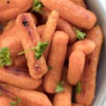 roasted baby carrots with parsley garnish