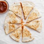 pizza quesadilla cut into wedges,like a pizza with dipping sauce