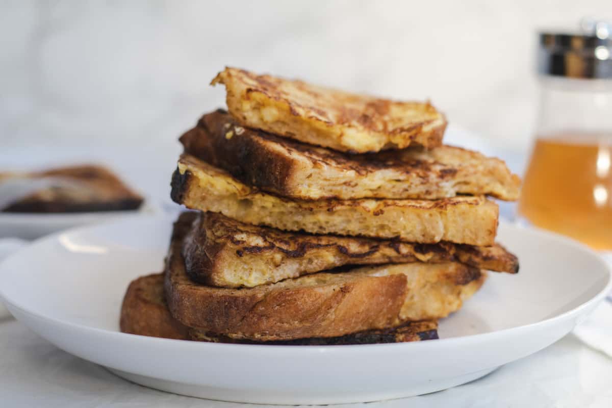stack of french toast on a white plate