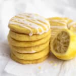 stack of lemon shortbread cookies with a squeezed lemon