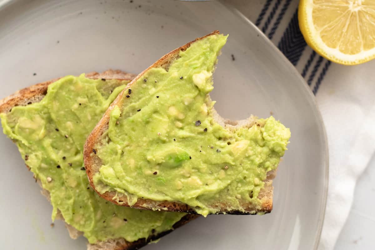 avocado toast with a bite taken out of it