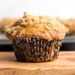 pumpkin muffin with streusel topping on a wooden board