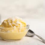 mango ice cream with coconut shreds on top