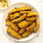 corn ribs piled on a white plate