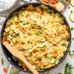 pot of steaming pasta primavera with a wooden spoon