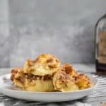 baked challah french toast on a plate with syrup in the background