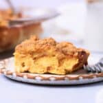 Piece of baked French toast casserole on a plate with a fork